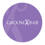 The Groombar logo in a purple circle with faded out scissors in the background