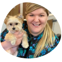 a picture of Megan Rozell, blonde woman holding a white dog